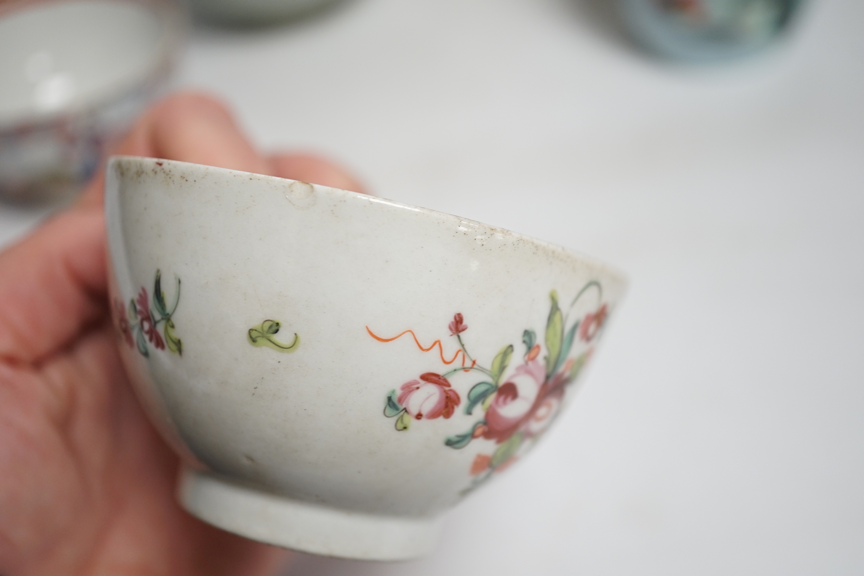 A collection of Chinese ceramics including celadon bowl decorated in low relief with fish, famille rose tea bowls and a jar, largest 12cm high